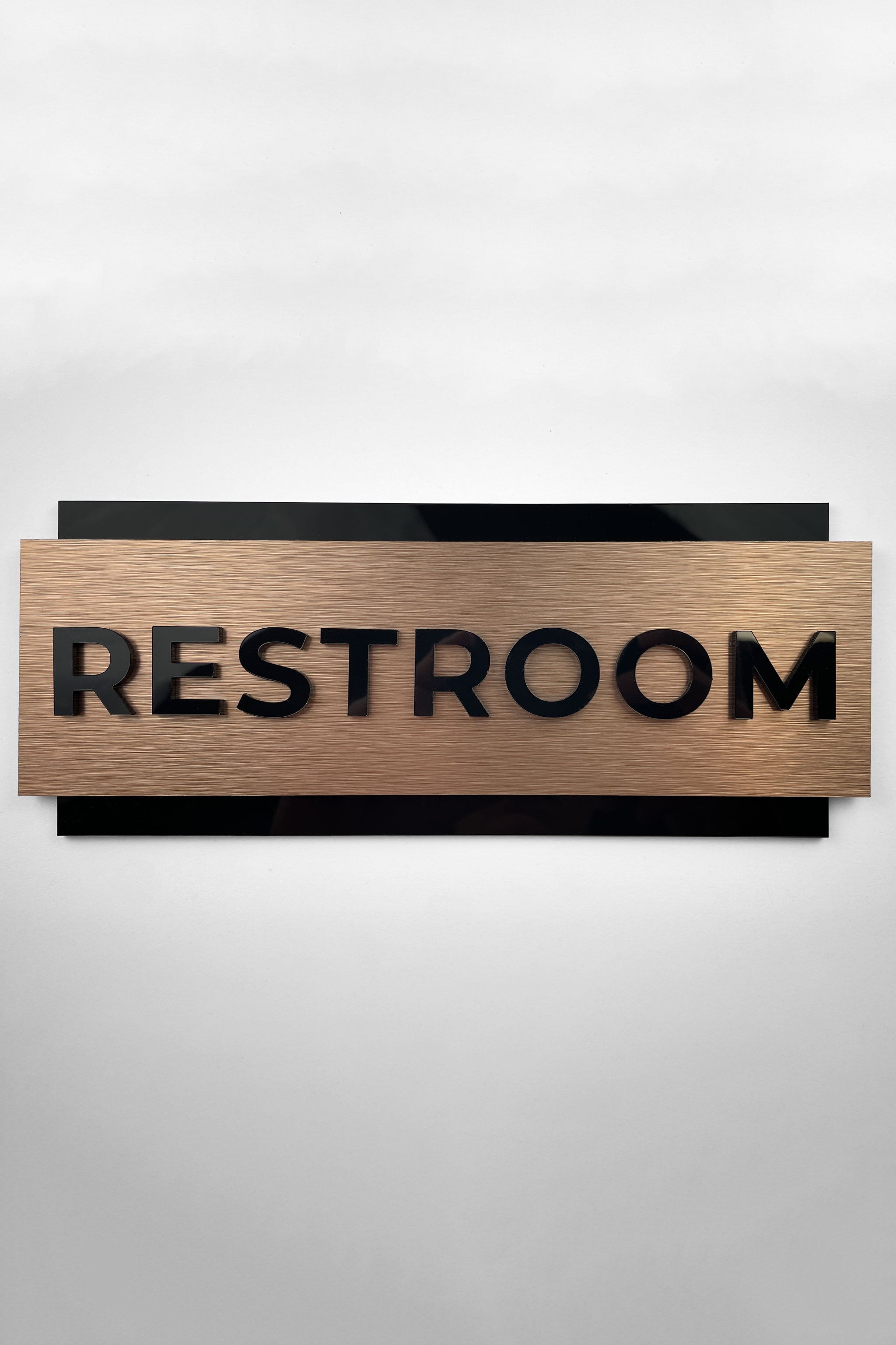 Custom bronze and acrylic office door sign by ALUMADESIGNCO featuring personalized text, modern signage for offices, meeting rooms, and contemporary interiors