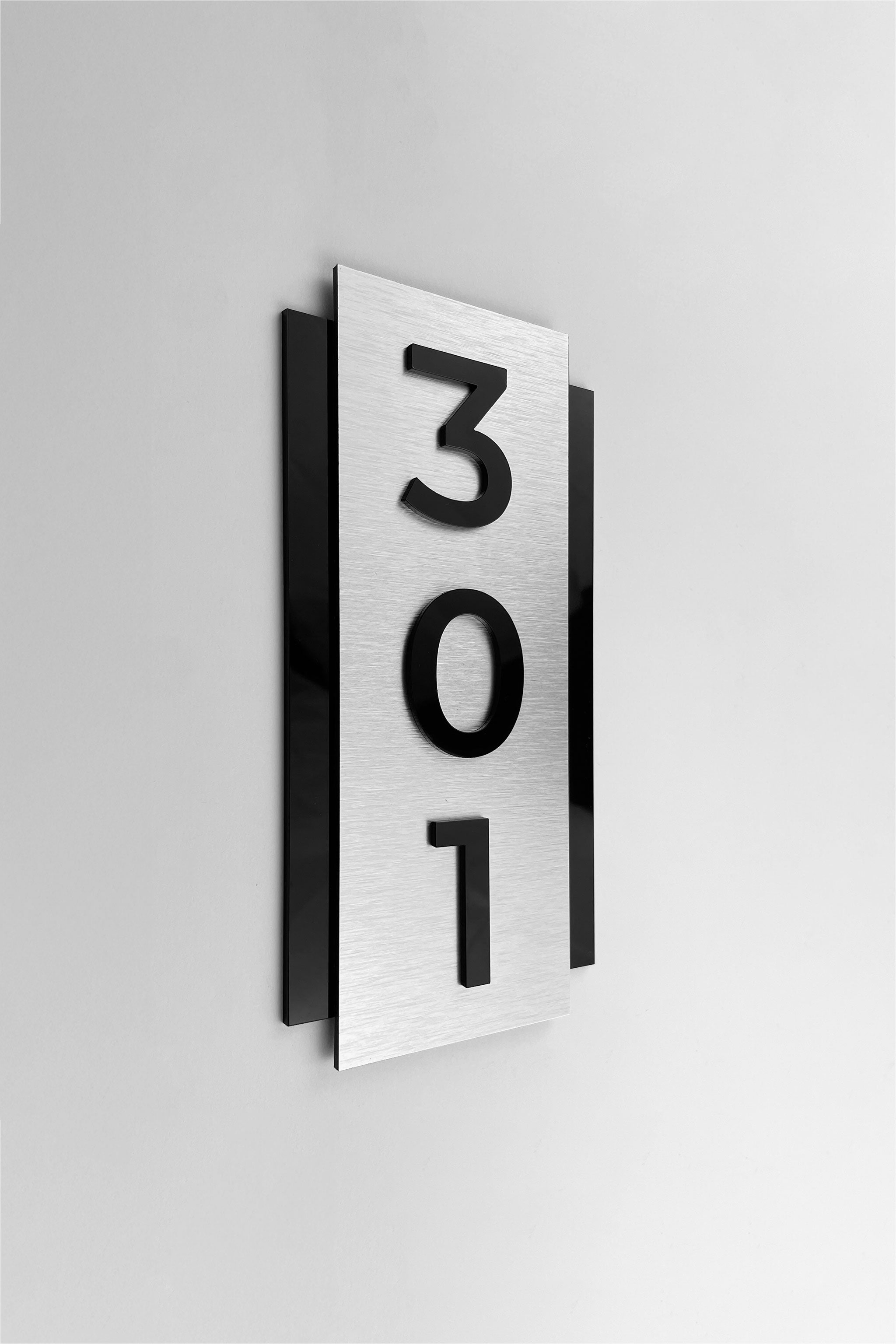 ALUMADESIGNCO brushed silver and acrylic vertical room number plaque with minimalist modern design, premium wall signage for hotels, offices, and apartments