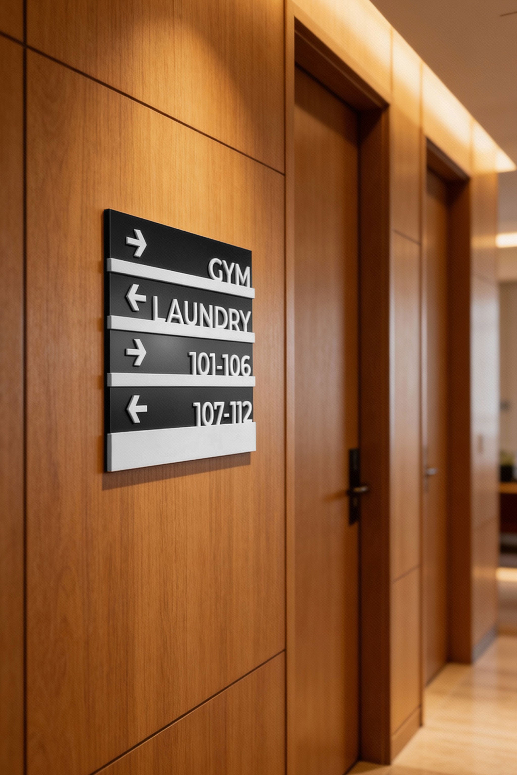 Modern wayfinding wall sign by ALUMADESIGNCO featuring elegant plaque design, directional signage for hotels, offices, and contemporary interiors