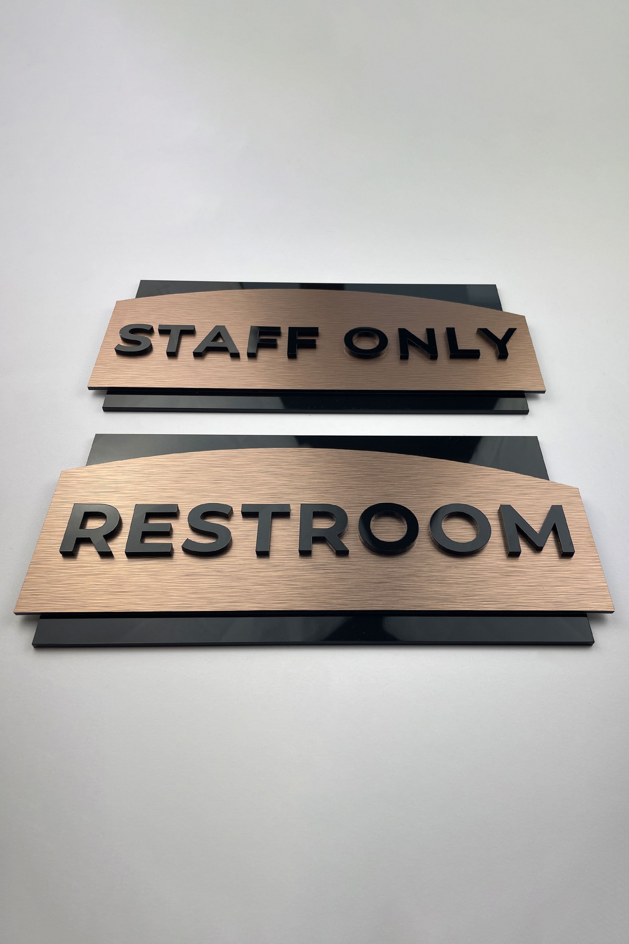 Custom brushed bronze and black acrylic office door sign by ALUMADESIGNCO, elegant door plaque for offices, meeting rooms, and contemporary interiors