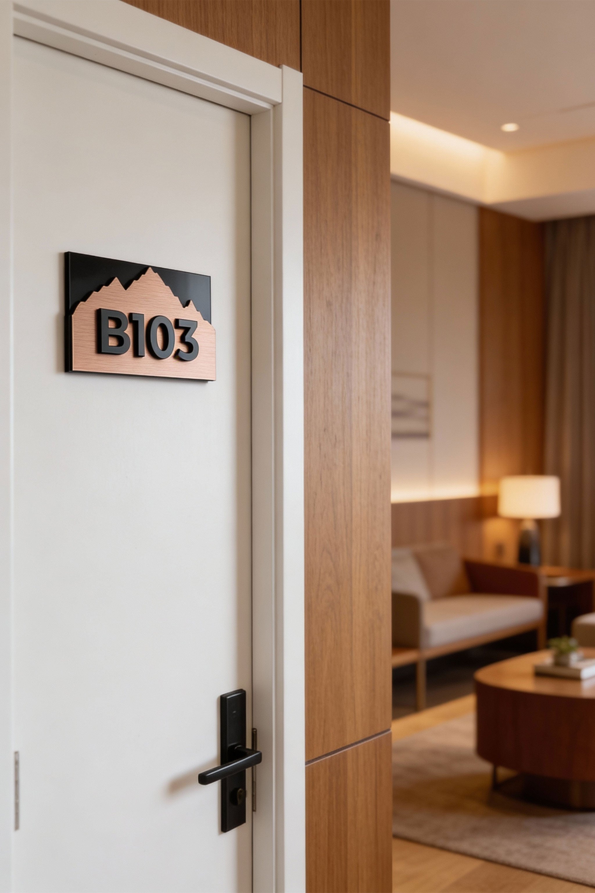Modern Alpine Design custom bronze hotel room number sign by ALUMADESIGNCO combining brushed bronze metal panel and acrylic numbers, stylish door signage