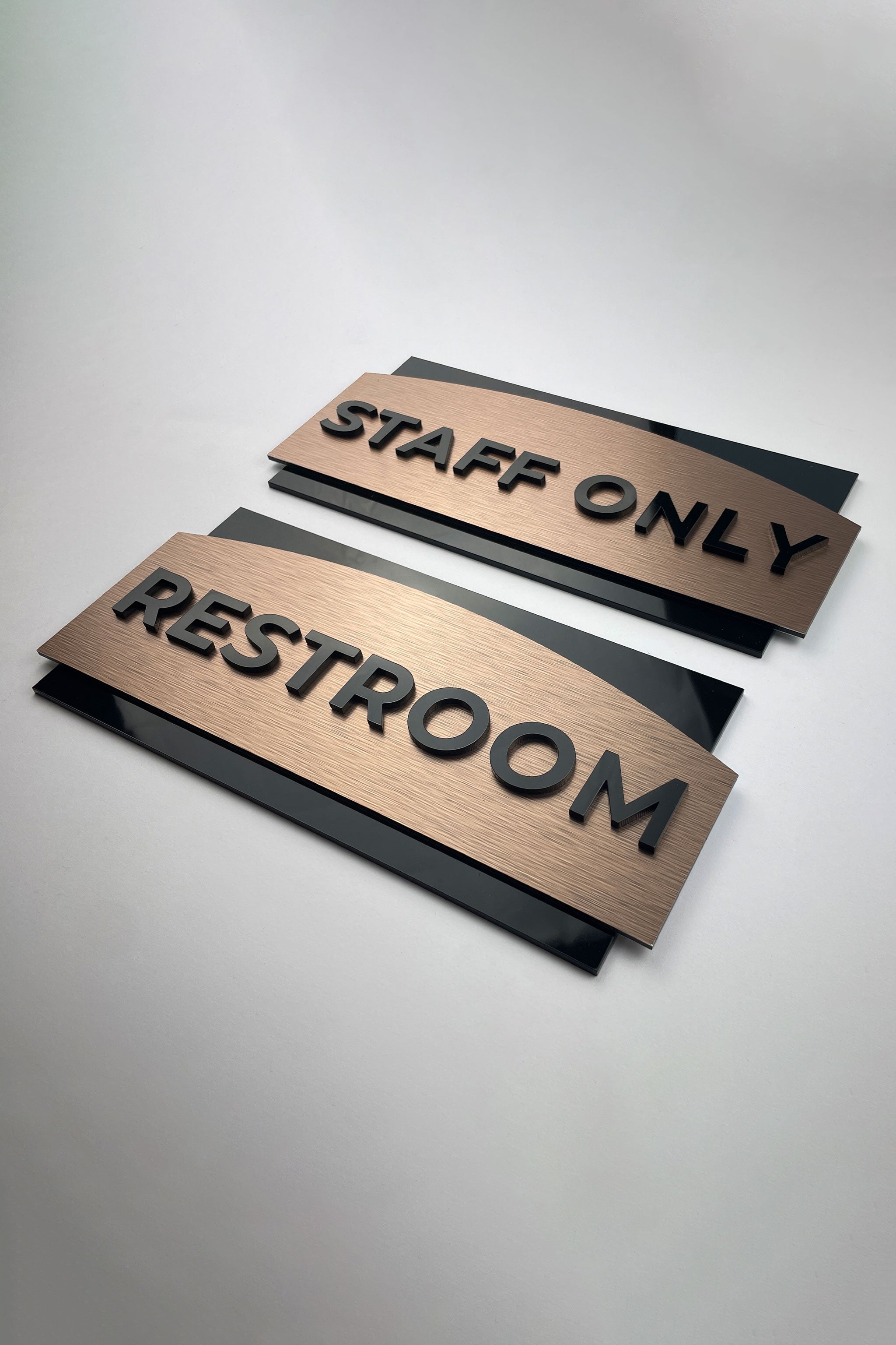 ALUMADESIGNCO brushed bronze office door plaque with black acrylic text, modern custom signage for offices, Airbnb properties, and commercial spaces