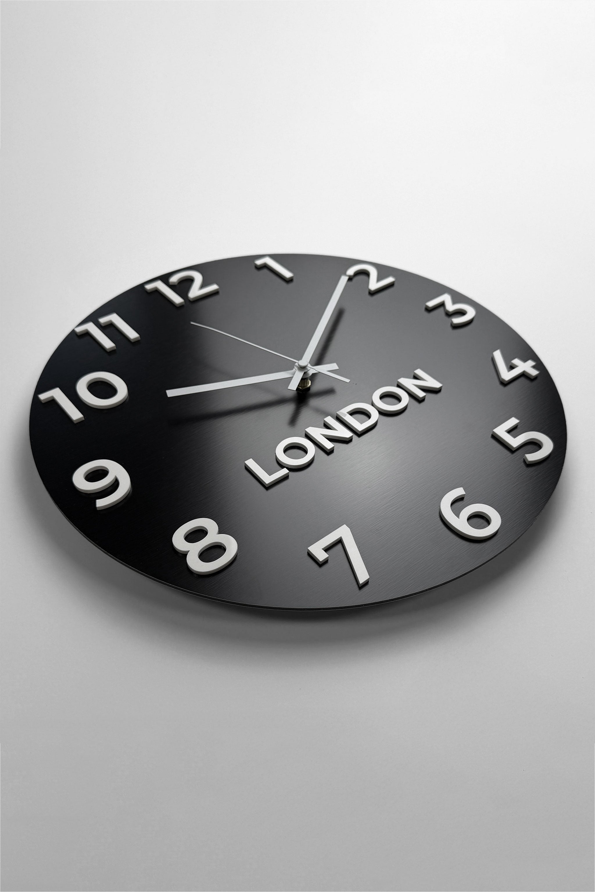 Modern customisable world time zone clock by ALUMADESIGNCO with personalized city name displays, stylish wall décor for offices and hospitality interiors