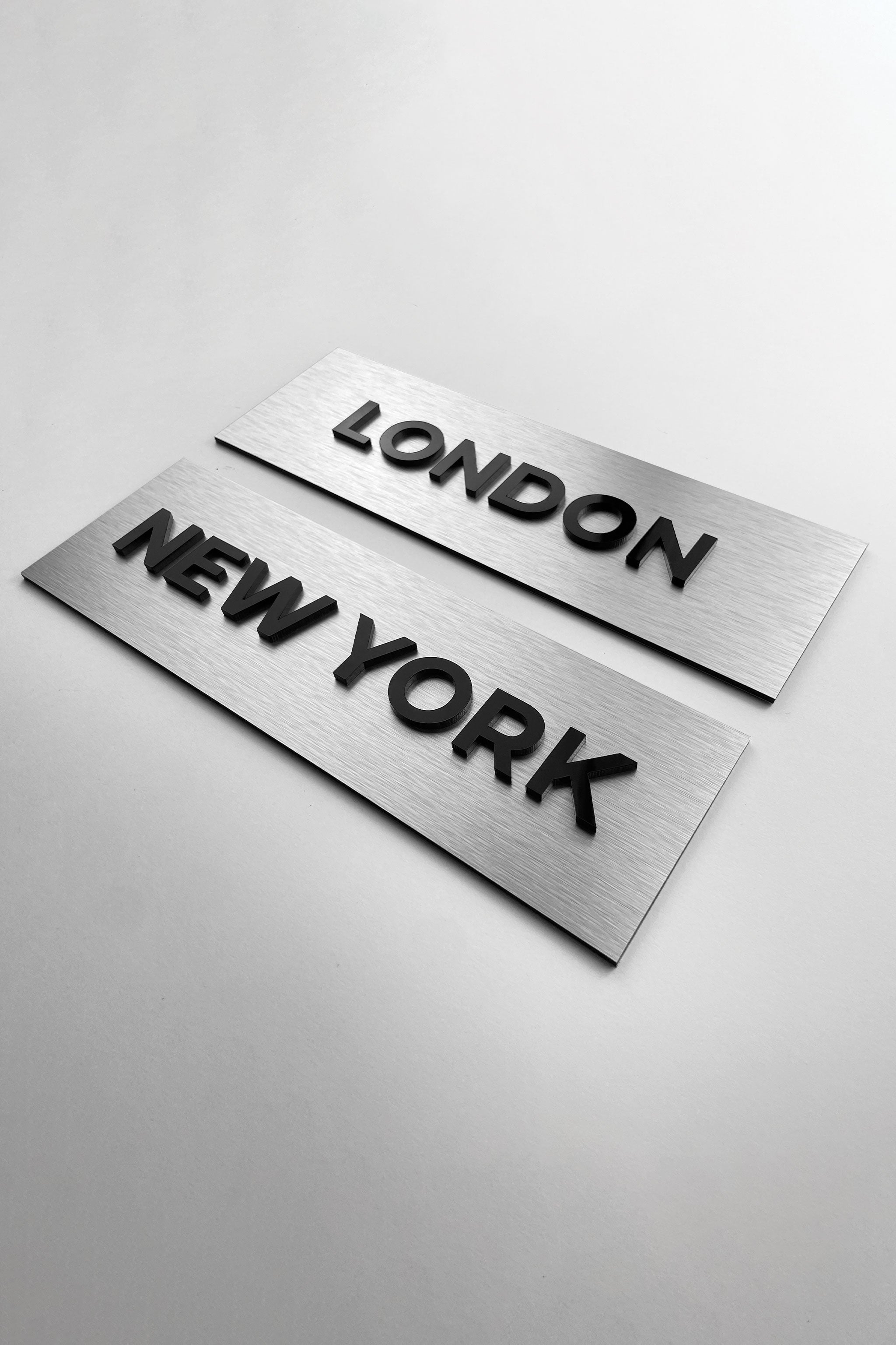 ALUMADESIGNCO brushed silver door plaque with black acrylic text, modern custom signage for offices, Airbnb properties, and commercial spaces