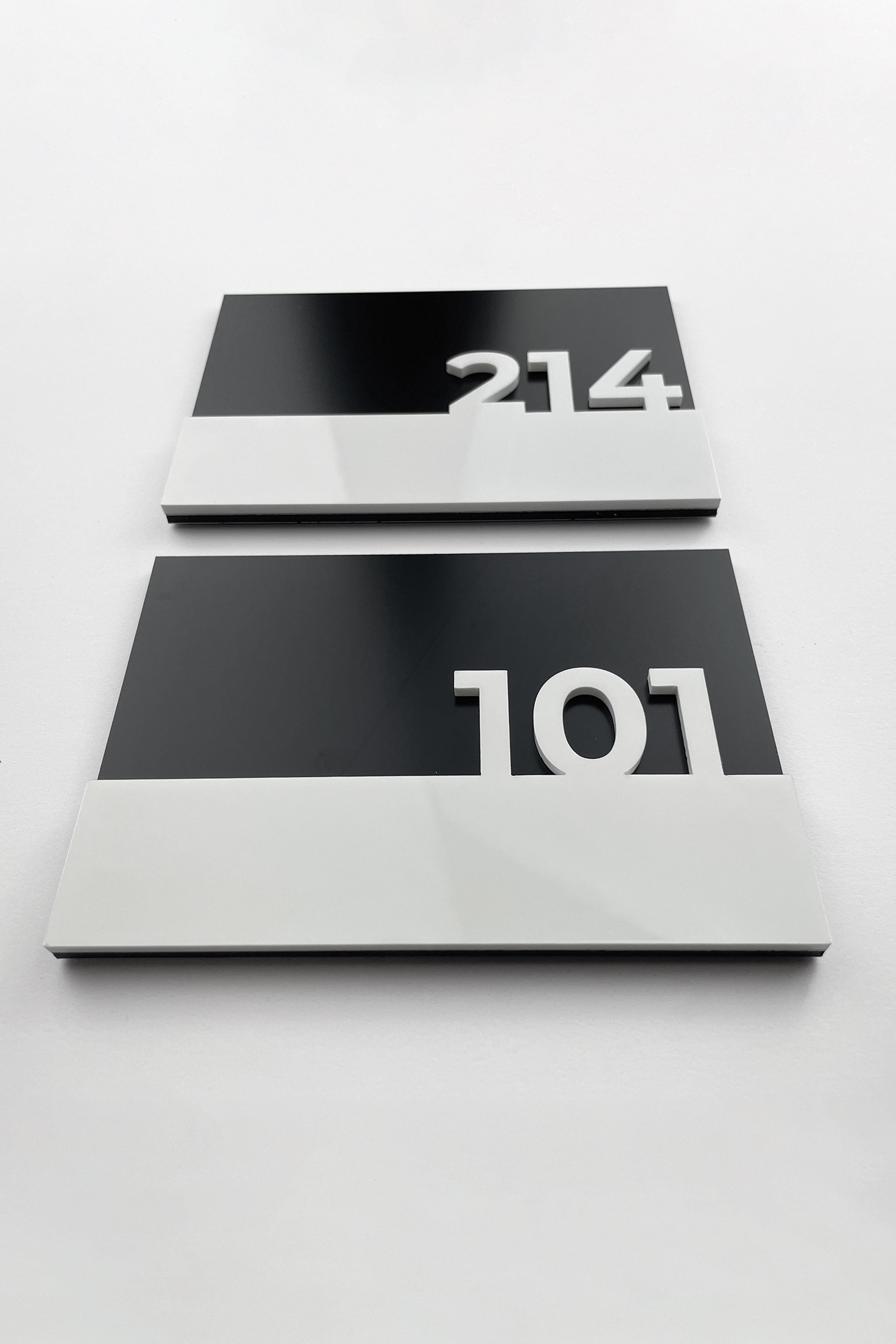 Elegant black door number sign Horizon Design by ALUMADESIGNCO featuring minimalist modern style and acrylic numbers, premium signage for hotel rooms and apartment interiors