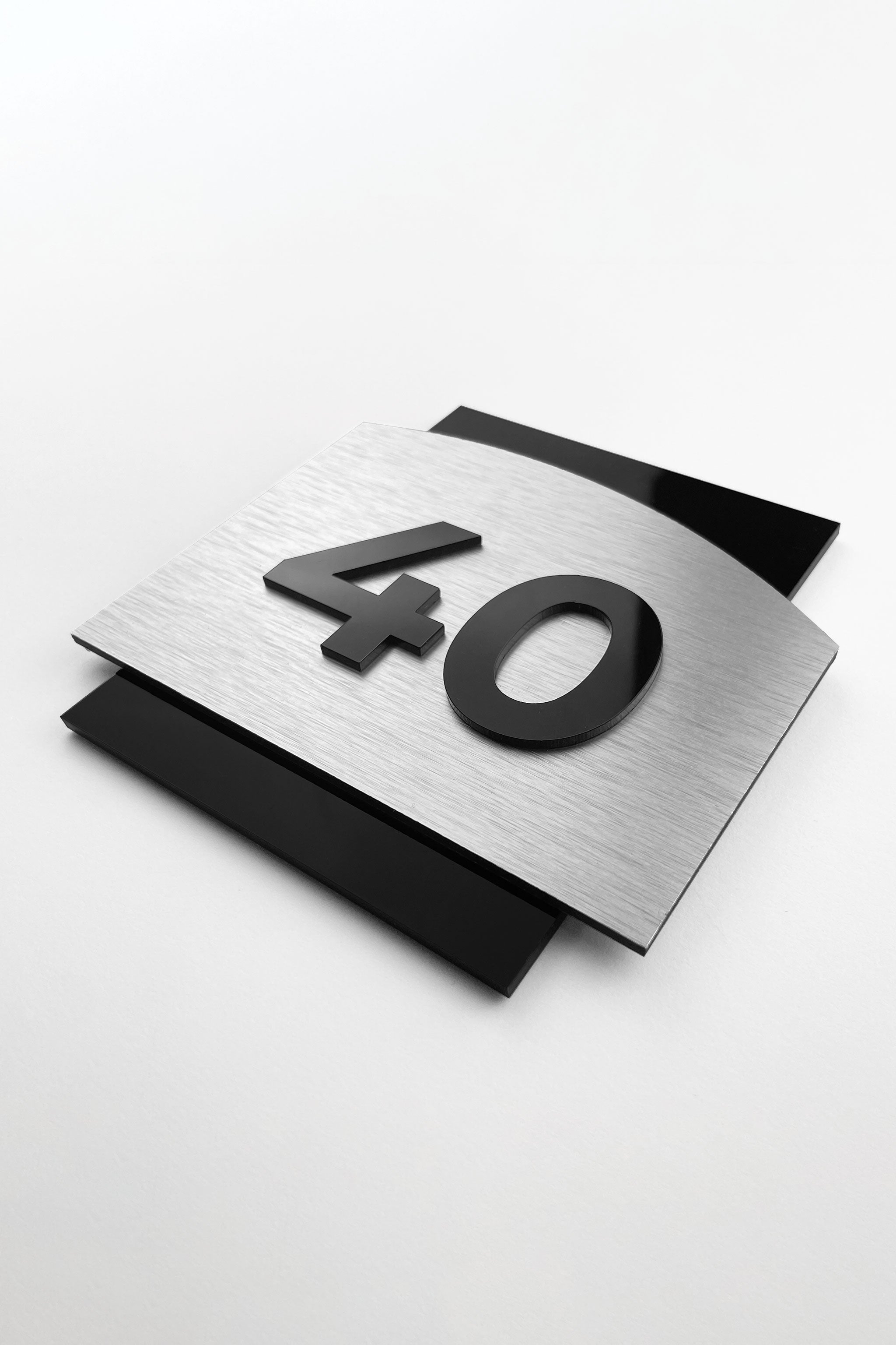 Modern 3D interior room number sign by ALUMADESIGNCO featuring raised acrylic numbers, stylish door signage for hotels, apartments, and contemporary interiors