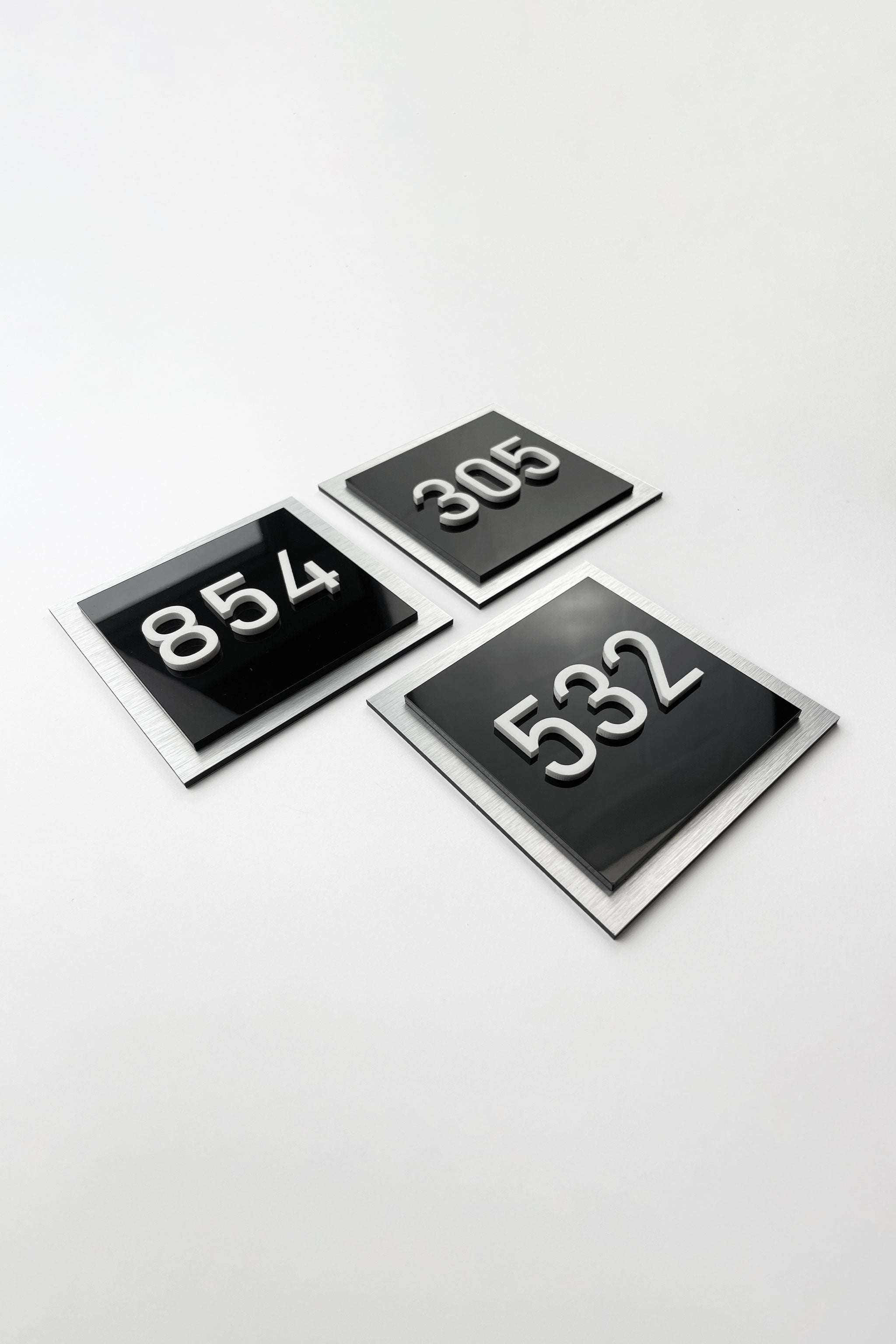 ALUMADESIGNCO layered apartment door number sign with 3D acrylic numbers, premium hotel signage for residential buildings and hospitality interiors