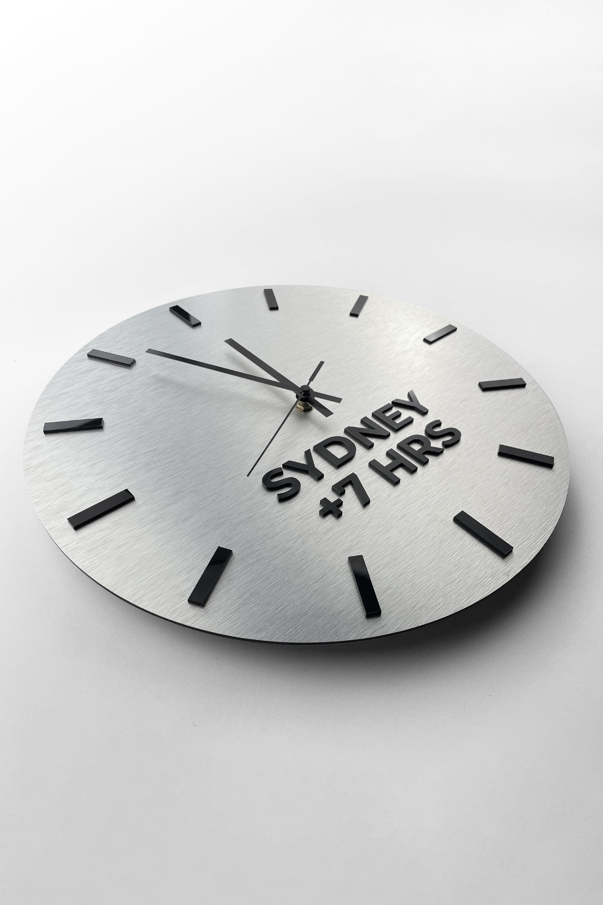 ALUMADESIGNCO brushed silver multi time zone wall clock with custom city labels, modern décor for offices, hotels, conference rooms, and interior design projects