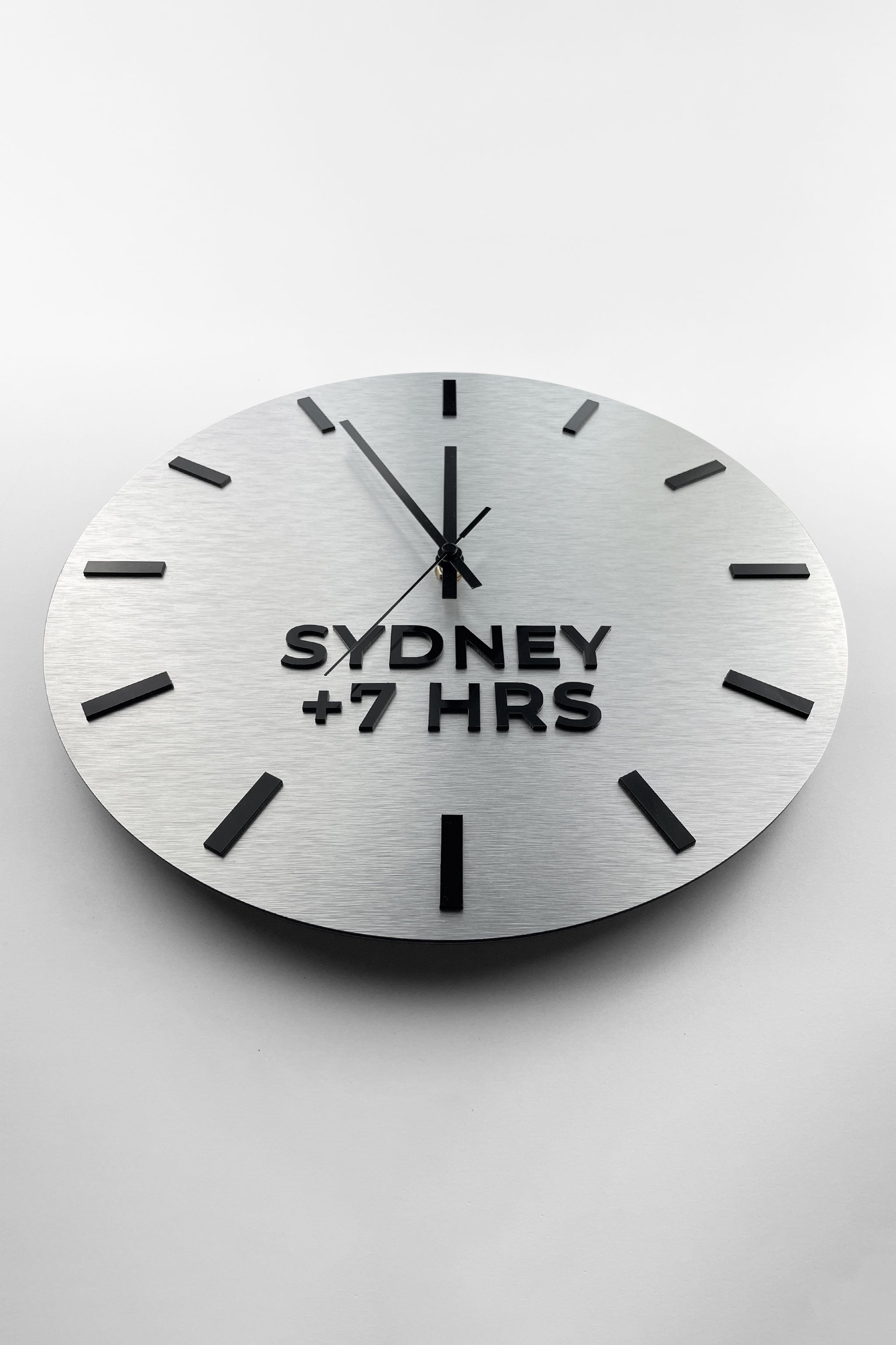 Premium brushed silver world time zone clock by ALUMADESIGNCO featuring multiple city name plaques, elegant wall clock for offices, reception areas, and modern spaces