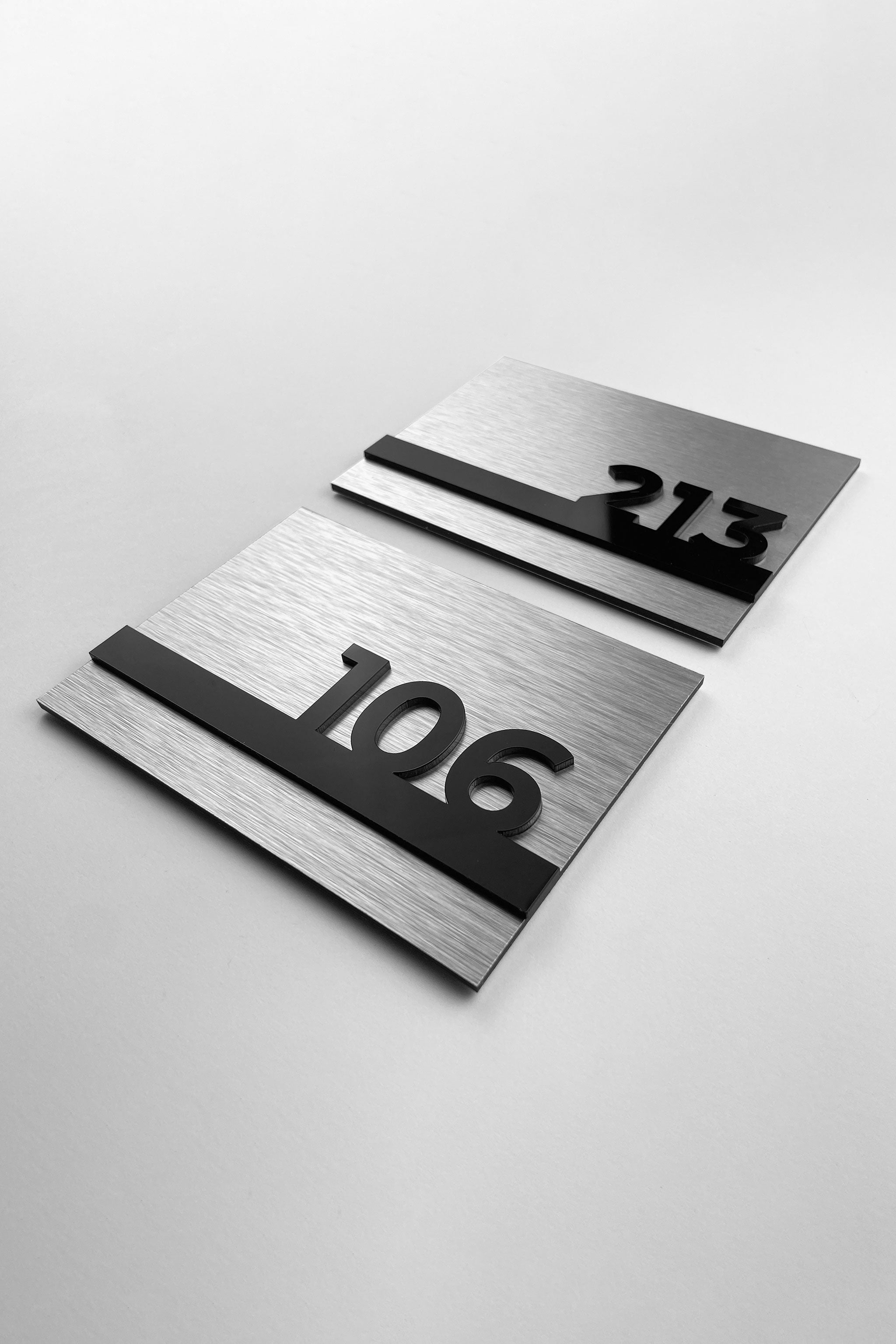 ALUMADESIGNCO silver hotel door number plaque with black acrylic numbers, custom signage for hotels, offices, and residential buildings