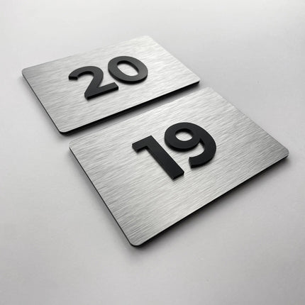 Premium room number sign for doors by ALUMADESIGNCO featuring brushed silver plaque and acrylic numbers, elegant door signage for hotels and offices