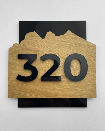 ALUMADESIGNCO Alpine collection door number sign featuring birch wood base and precision cut black acrylic numbers, modern Scandinavian style room number plaque designed for hotels, Airbnb properties, and apartment buildings