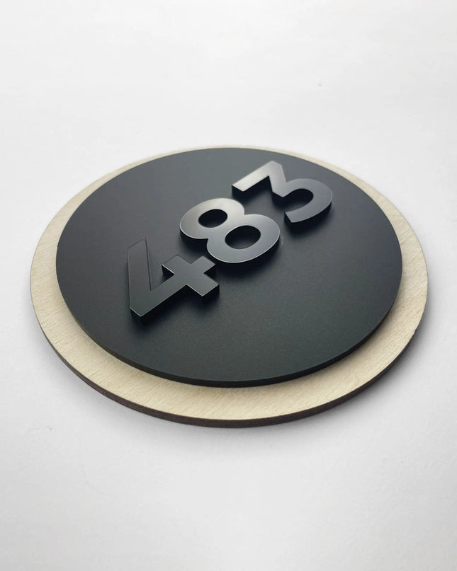 Round hotel room number sign by ALUMADESIGNCO crafted from birch plywood with raised black acrylic glass numbers, modern Scandinavian door number plaque for hotel corridors and apartments