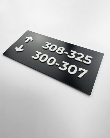 Black and white wayfinding sign wall plaque in Modern Design by ALUMADESIGNCO, stylish directional signage for offices, hotels, corridors, and modern interior spaces
