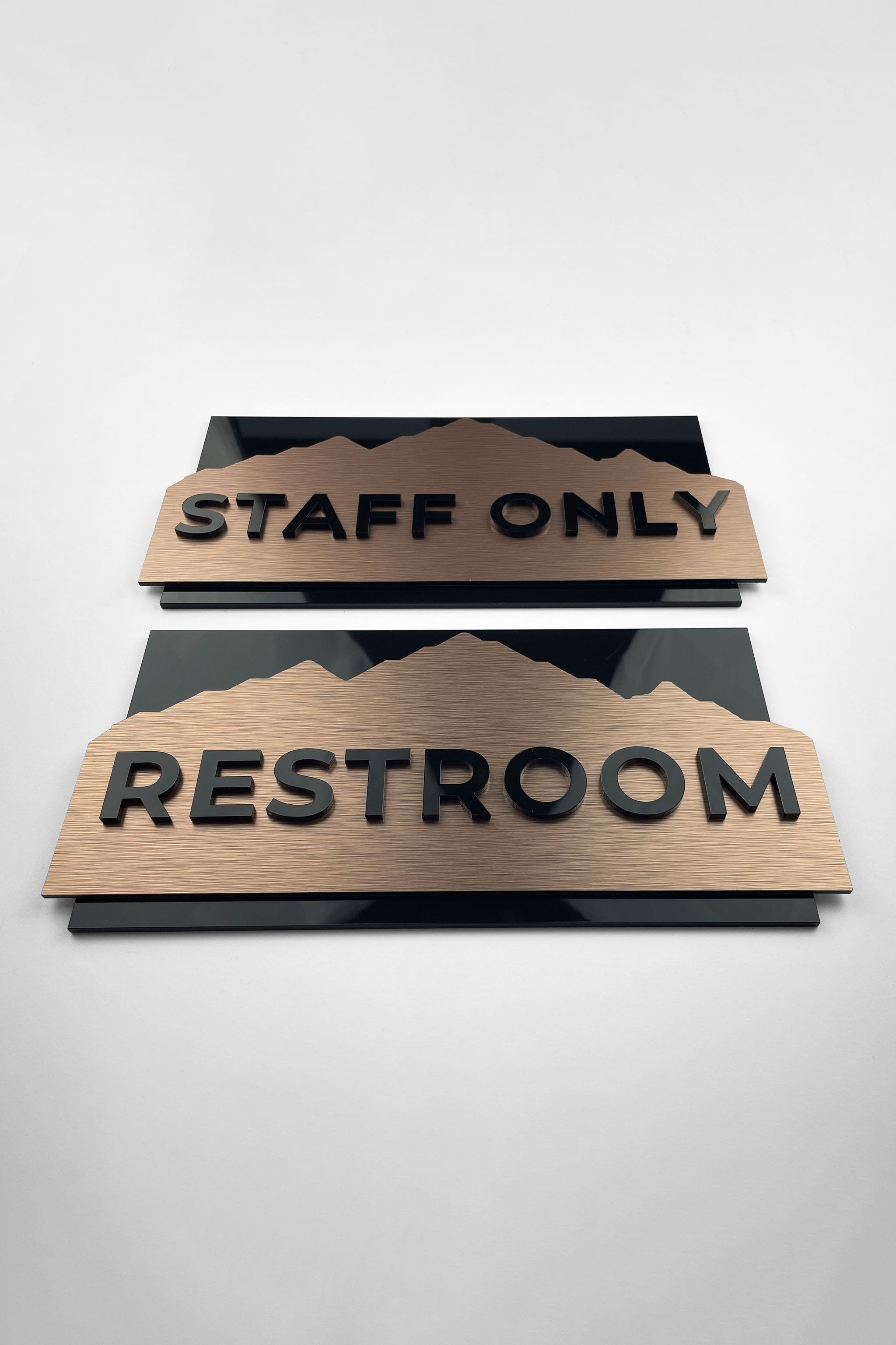 Custom brushed bronze and black acrylic interior door sign by ALUMADESIGNCO, elegant plaque for office doors, hotel interiors, and apartment spaces