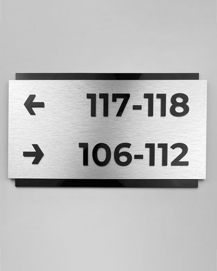 Custom brushed silver and black acrylic directional sign by ALUMADESIGNCO, modern wayfinding plaque for hotels, offices, corridors, and contemporary interior spaces