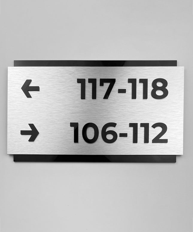 Custom brushed silver and black acrylic directional sign by ALUMADESIGNCO, modern wayfinding plaque for hotels, offices, corridors, and contemporary interior spaces