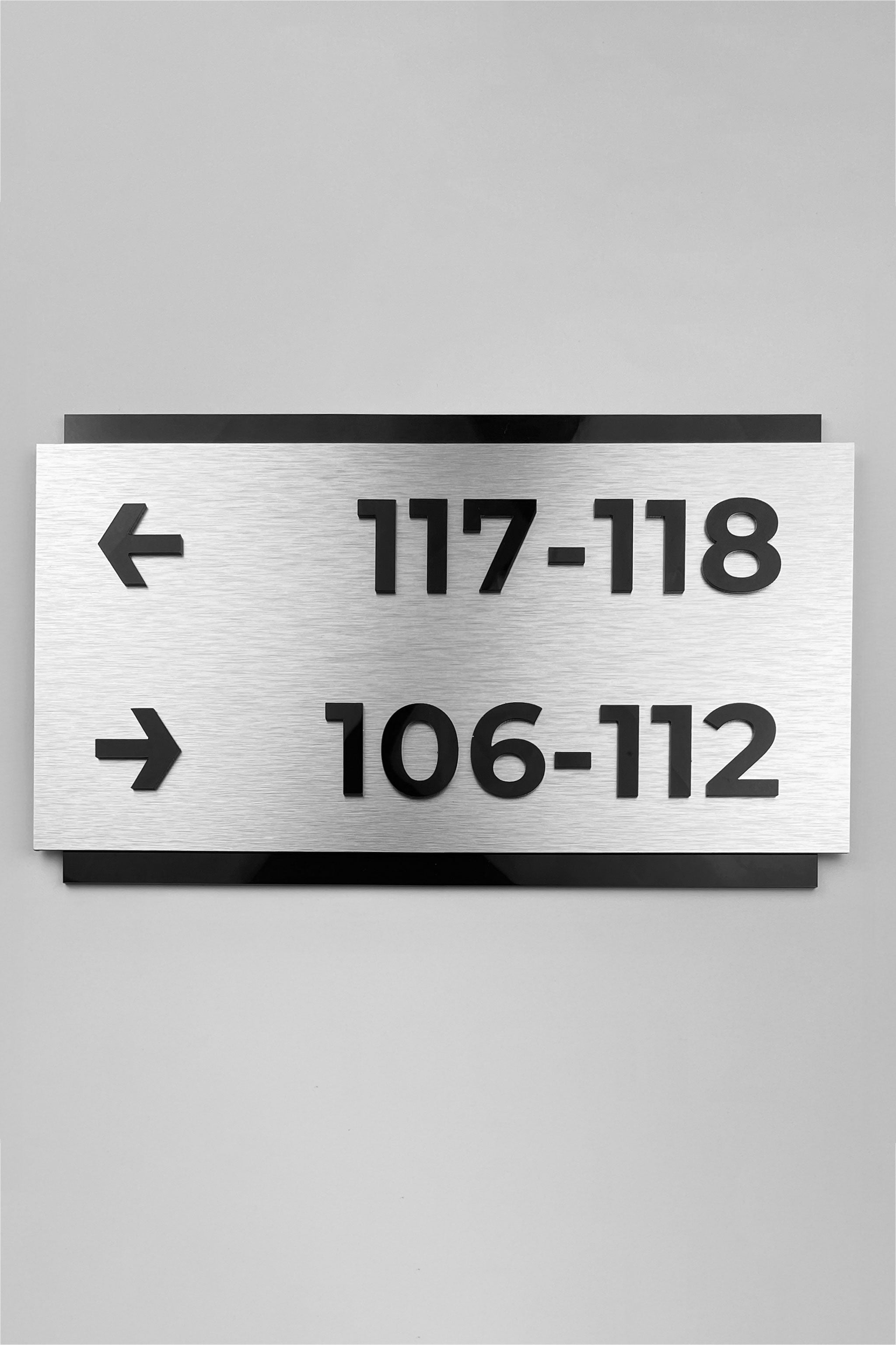 Custom brushed silver and black acrylic directional sign by ALUMADESIGNCO, modern wayfinding plaque for hotels, offices, corridors, and contemporary interior spaces