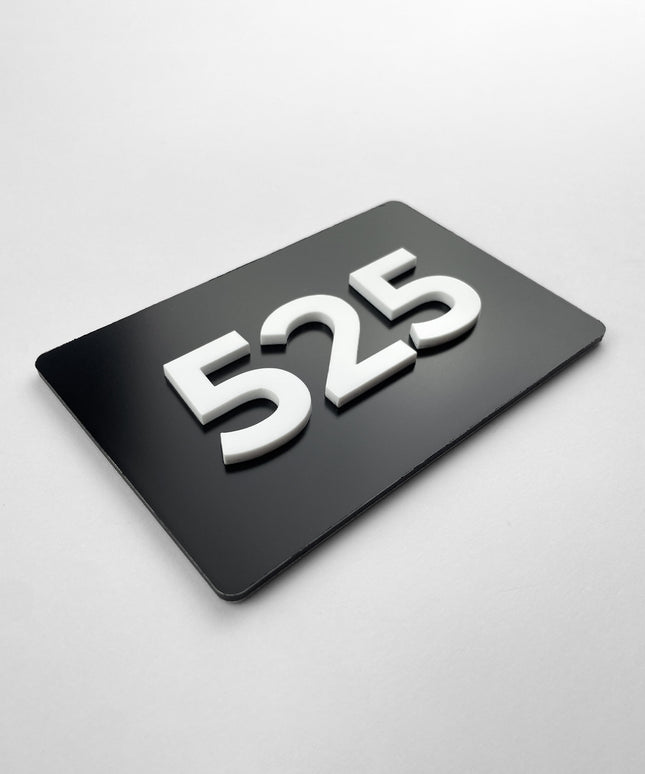 Custom black metal and white acrylic room number sign by ALUMADESIGNCO, modern door plaque for hotel rooms, apartment doors, and contemporary interiors