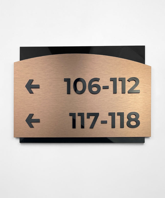 ALUMADESIGNCO Flow Design interior directional sign with brushed bronze plaque and acrylic text, premium wayfinding signage for offices, hotels, apartments, and contemporary interiors