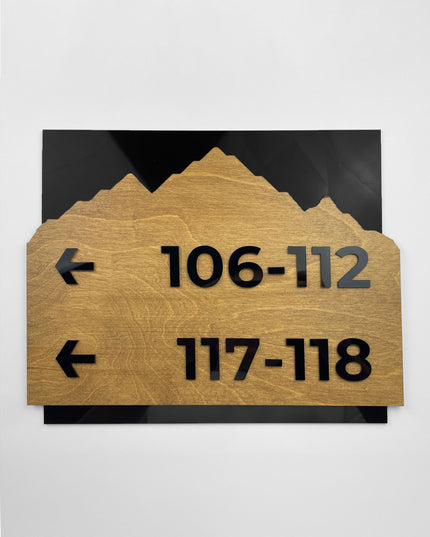 Modern Alpine Design wayfinding sign by ALUMADESIGNCO combining birch wood plaque and black acrylic text, premium directional signage for hotels, offices, and contemporary interiors