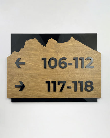 ALUMADESIGNCO Alpine Design custom directional sign with birch wood base and black acrylic text, premium wayfinding signage for offices, hotels, apartments, and contemporary interiors
