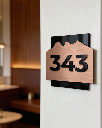 Brushed bronze hotel room number sign Alpine Design by ALUMADESIGNCO featuring metal plaque and acrylic numbers, elegant door signage for hotel corridors and apartments