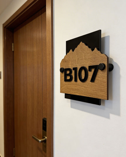 Customisable Alpine wooden hotel wall number sign by ALUMADESIGNCO featuring natural wood base and standoff mounting hardware, modern room number plaque for hotels and apartments