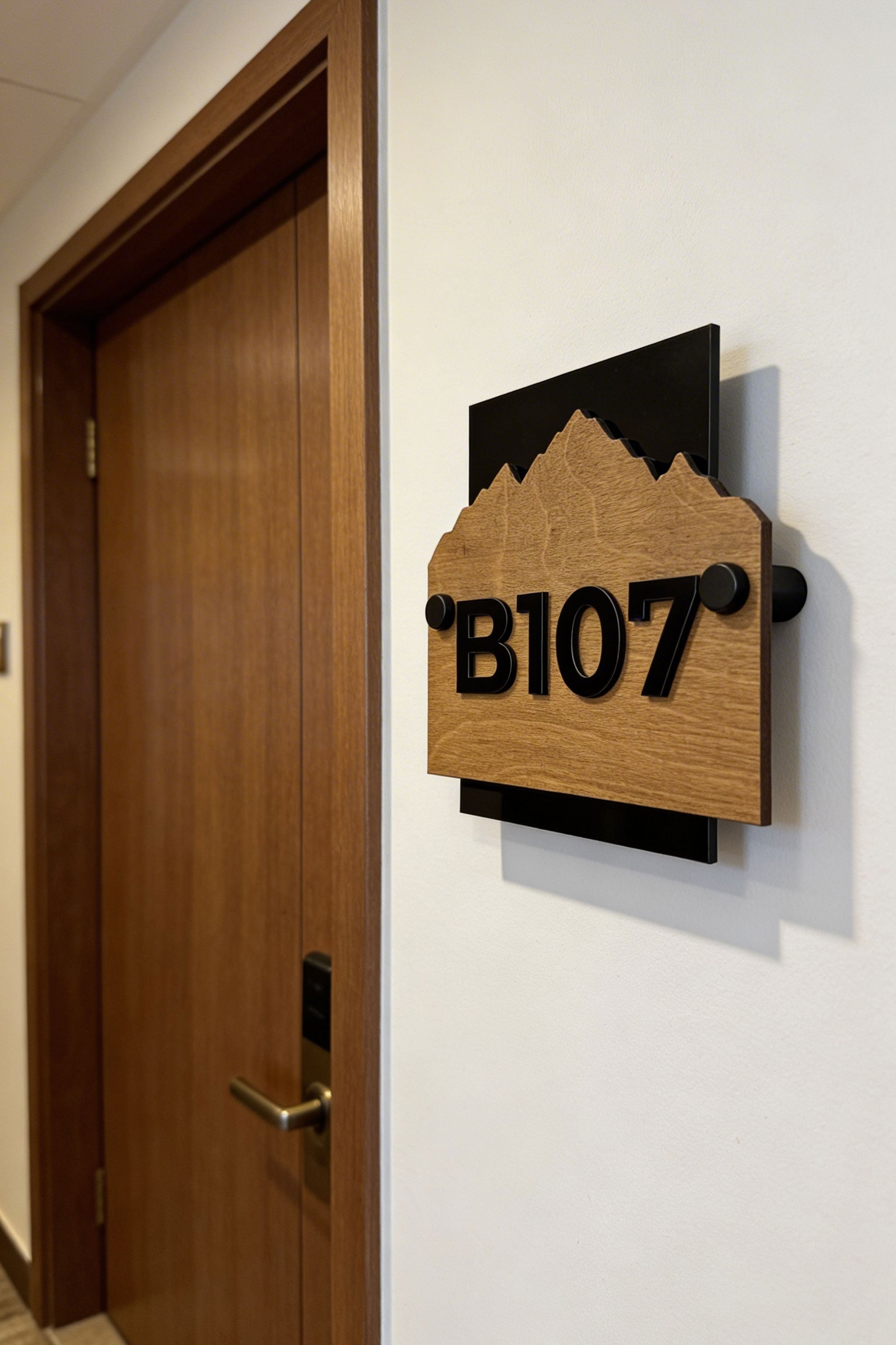 Customisable Alpine wooden hotel wall number sign by ALUMADESIGNCO featuring natural wood base and standoff mounting hardware, modern room number plaque for hotels and apartments