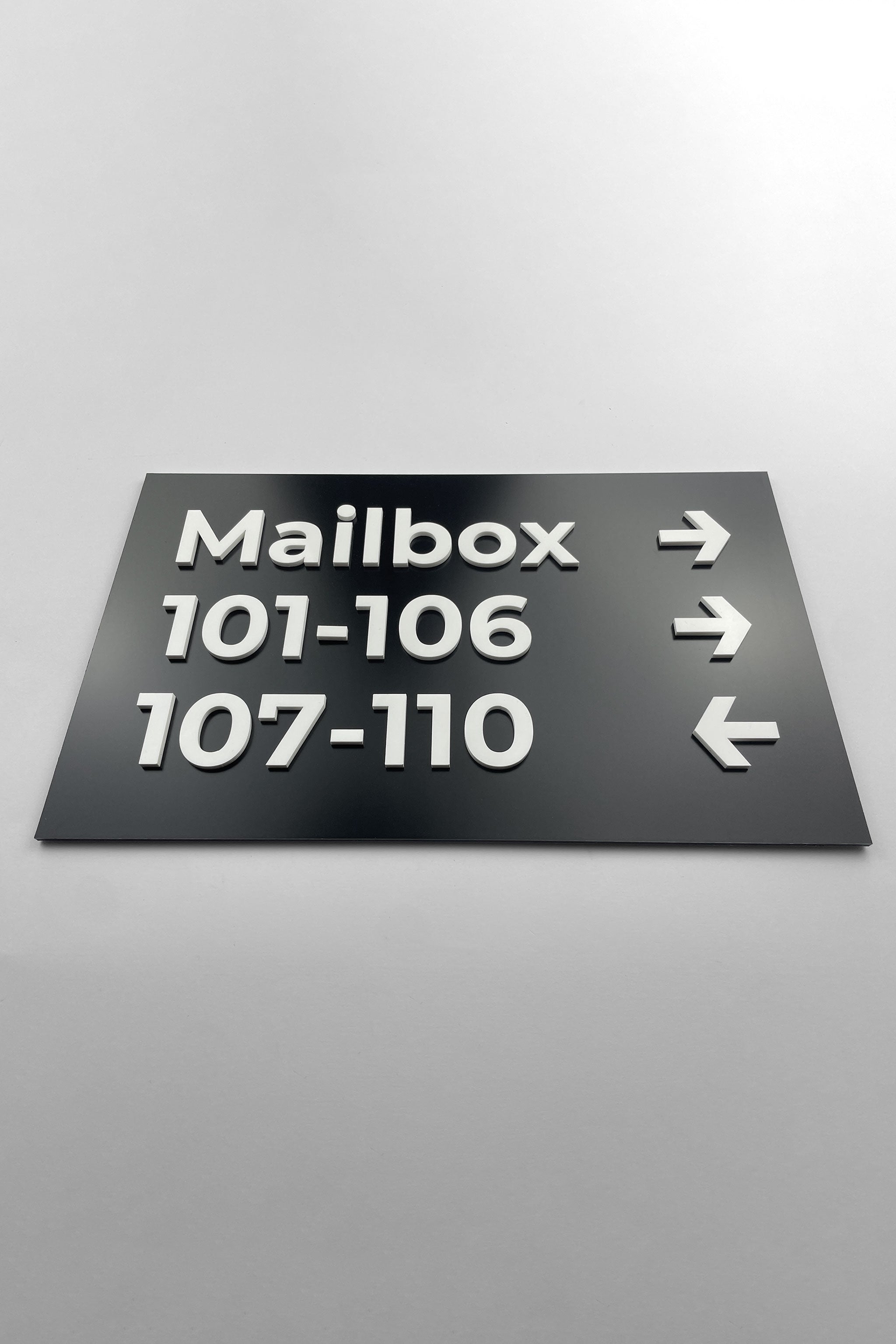 ALUMADESIGNCO directional wall plaque with black and white Modern Design styling, premium wayfinding signage for offices, hospitality spaces, apartment buildings, and interiors