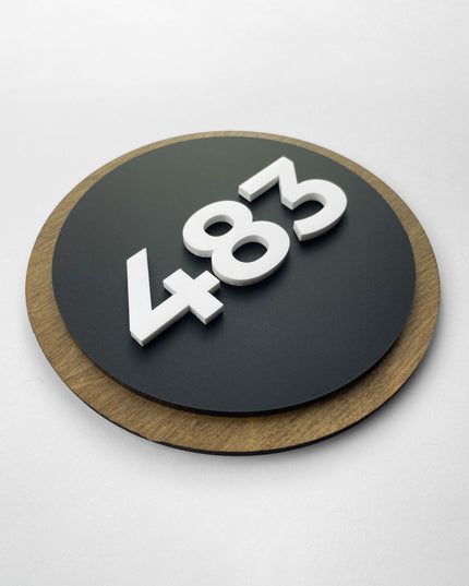 Modern Round Design room number plaque by ALUMADESIGNCO made from natural birch wood and black acrylic numbers, elegant door number sign for hotel rooms and apartment doors