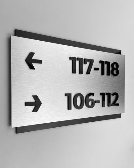 Modern custom wayfinding sign by ALUMADESIGNCO combining brushed silver plaque and black acrylic text, elegant directional signage for commercial and hospitality spaces