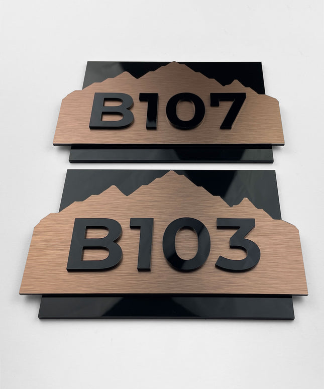Modern brushed bronze room number sign Alpine Design by ALUMADESIGNCO featuring metal plaque and acrylic numbers, elegant door signage for hotel rooms and apartment interiors