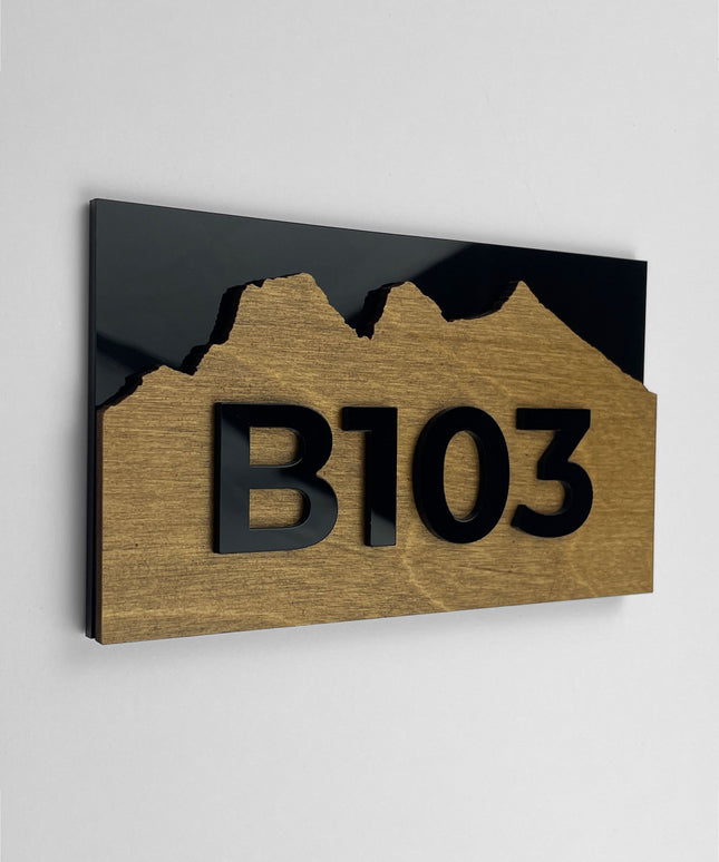 Birch plywood apartment door number sign Alpine Design by ALUMADESIGNCO featuring natural wood base and acrylic glass numbers for modern apartment and hotel interiors