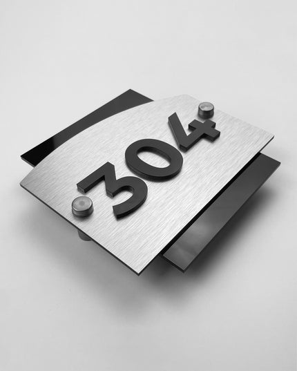Brushed silver hotel room number sign Flow Design by ALUMADESIGNCO featuring metal panel and acrylic 3D numbers, modern hotel door signage for corridors and apartments