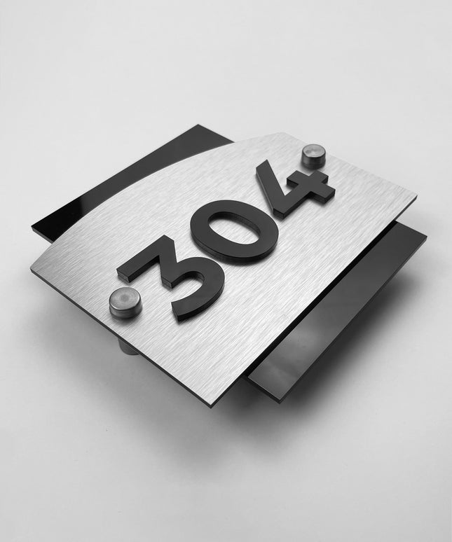 Brushed silver hotel room number sign Flow Design by ALUMADESIGNCO featuring metal panel and acrylic 3D numbers, modern hotel door signage for corridors and apartments