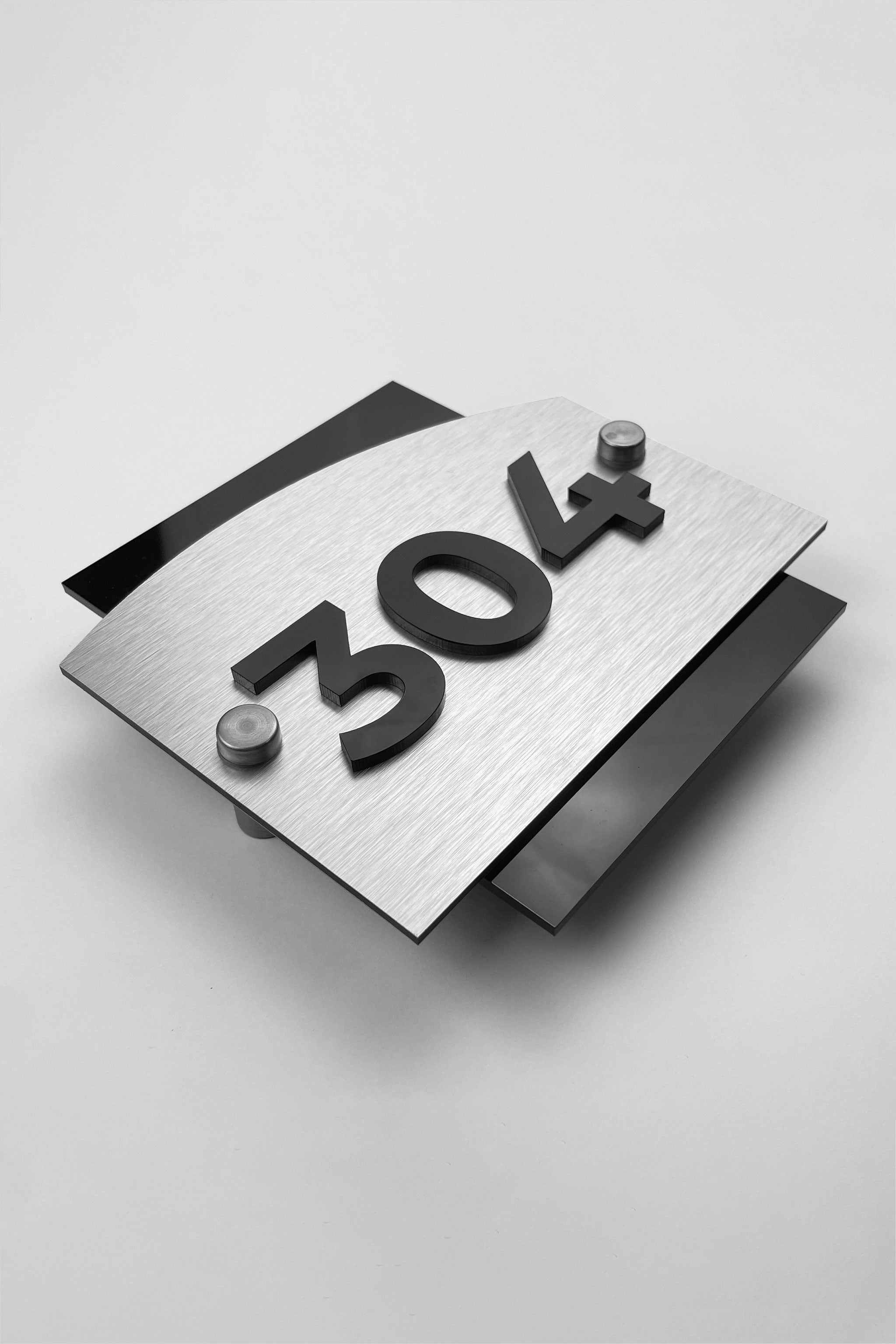 Brushed silver hotel room number sign Flow Design by ALUMADESIGNCO featuring metal panel and acrylic 3D numbers, modern hotel door signage for corridors and apartments