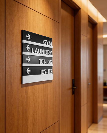 Modern wayfinding wall sign by ALUMADESIGNCO featuring elegant plaque design, directional signage for hotels, offices, and contemporary interiors