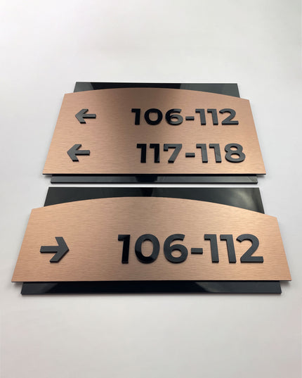 Brushed bronze and acrylic interior directional sign Flow Design by ALUMADESIGNCO, elegant wayfinding plaque for hotels, offices, corridors, and modern interior spaces