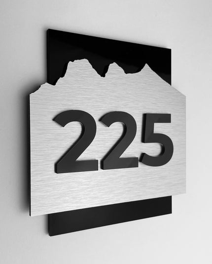 Hotel room number sign Alpine Design by ALUMADESIGNCO featuring brushed silver metal panel and black acrylic numbers, modern door plaque for hotel corridors and apartment interiors