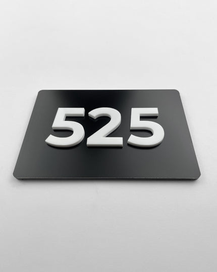 ALUMADESIGNCO black metal door number plaque with white acrylic numbers, custom signage for hotels, offices, and residential buildings