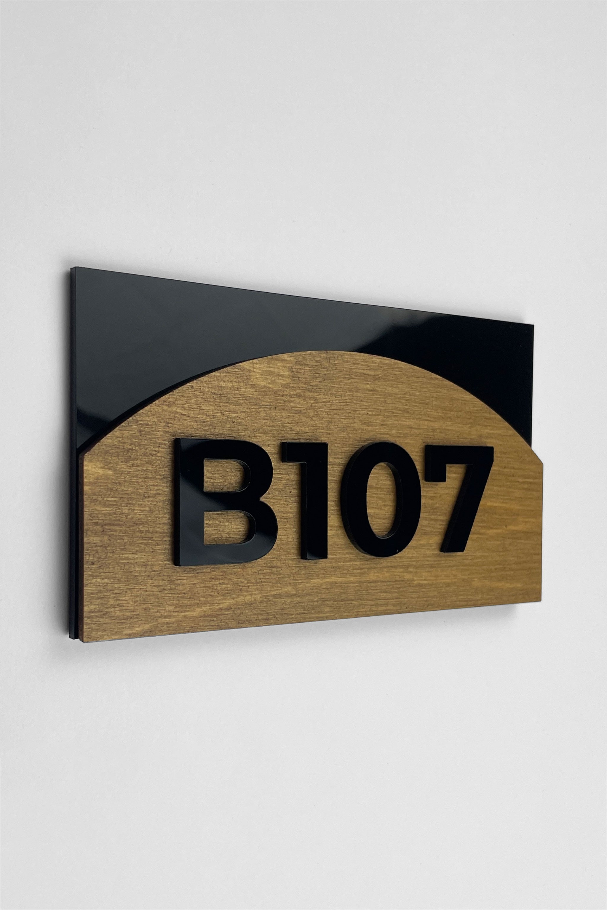 Birch plywood room number sign Flow Design by ALUMADESIGNCO featuring natural wood base and acrylic glass numbers for modern hotel rooms and apartment doors