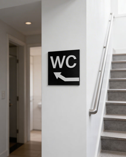 ALUMADESIGNCO WC sign with upstairs arrow and minimalist modern style, restroom wayfinding signage for offices, hotels, cafés, and contemporary interiors