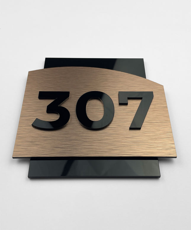Luxury bronze and acrylic glass hotel room number sign by ALUMADESIGNCO, elegant door plaque for hotel corridors and apartment interiors
