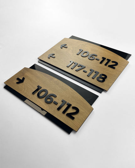 Premium Flow arrow directional wall sign by ALUMADESIGNCO featuring birch wood plate and black acrylic lettering, modern wayfinding signage for hospitality and office interiors