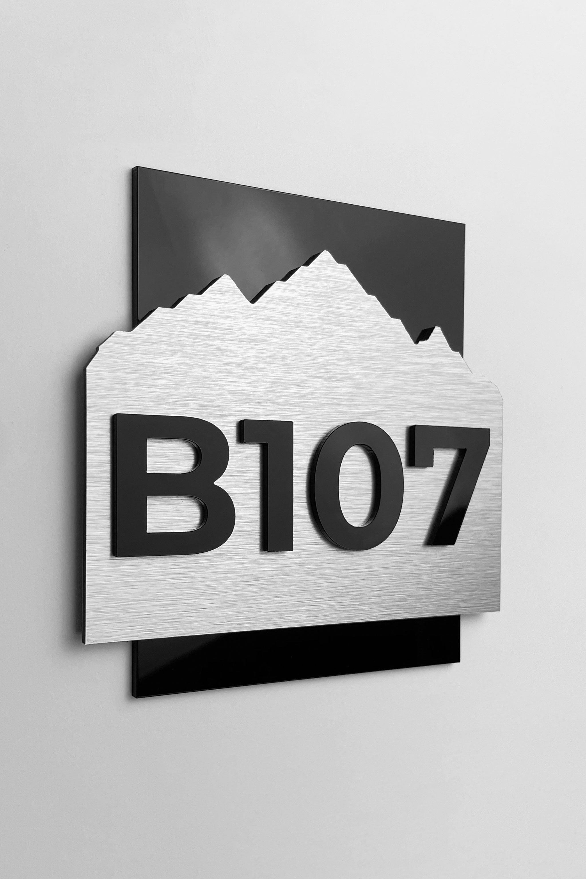 3D layered hotel room number sign Alpine Design by ALUMADESIGNCO featuring wood and acrylic layers, modern door plaque for hotel corridors and apartment interiors