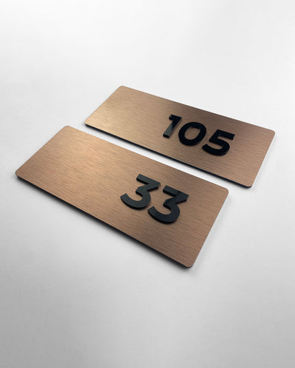 Premium Classic brushed bronze apartment number sign by ALUMADESIGNCO featuring raised acrylic numbers, modern door signage for apartments and hotel interiors