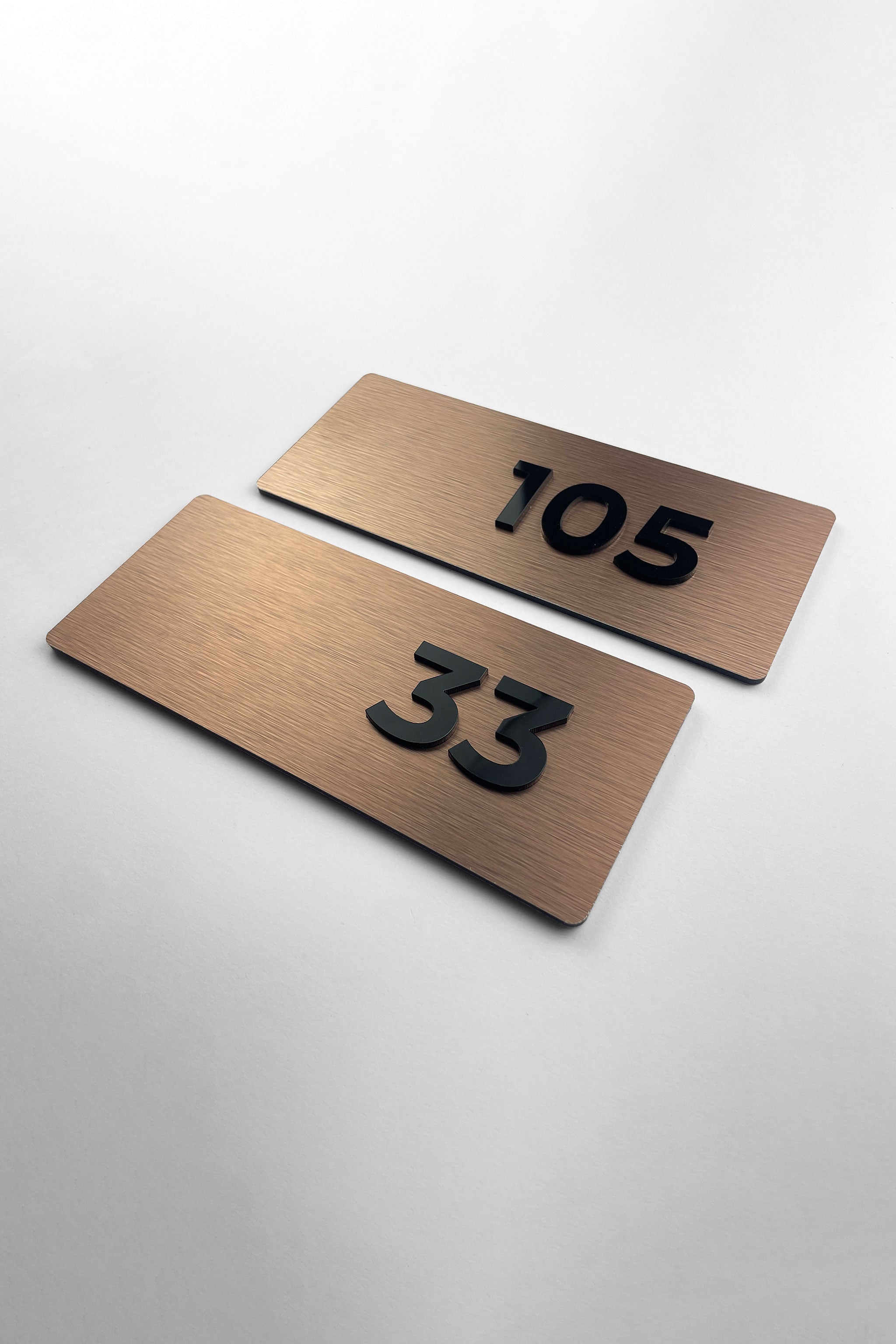 Premium Classic brushed bronze apartment number sign by ALUMADESIGNCO featuring raised acrylic numbers, modern door signage for apartments and hotel interiors