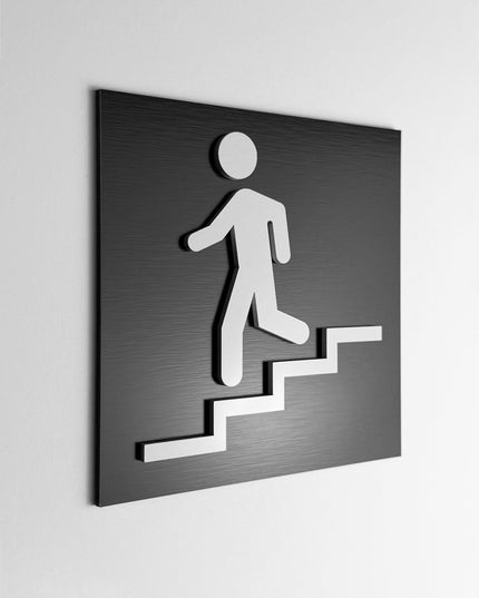 ALUMADESIGNCO stairwell sign downstairs with modern directional style, premium wayfinding signage for offices, hotels, apartments, and commercial interiors