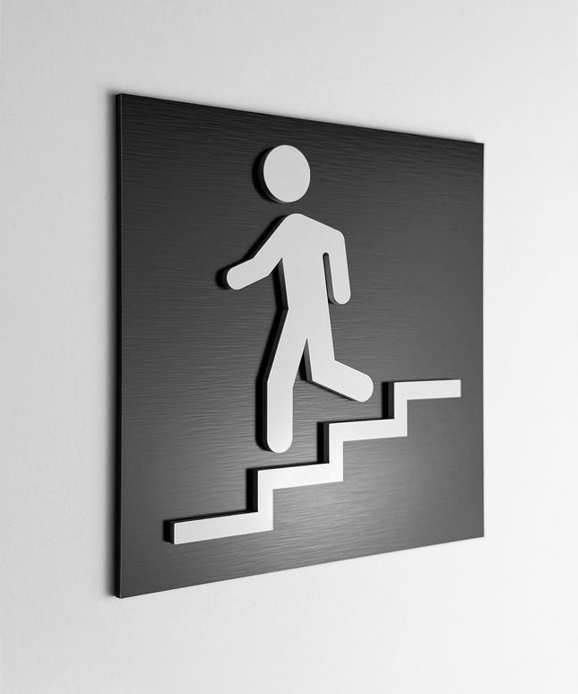 ALUMADESIGNCO stairwell sign downstairs with modern directional style, premium wayfinding signage for offices, hotels, apartments, and commercial interiors